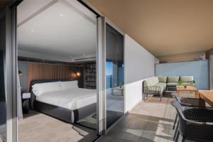 a bedroom with a bed and a living room at Hotel SB Win 4 Sup in Sant Feliu de Llobregat