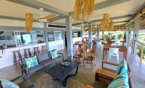 a living room with a couch and a bar at Komba on the Rocks in Nosy Komba
