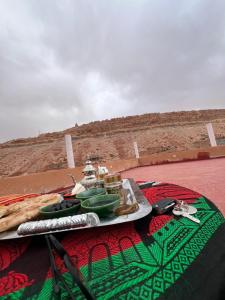 a table with a plate of food on a table at Pergolas Tamakoucht in Ouarzazate