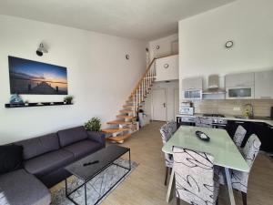 a living room with a couch and a table at Apartment Perla in Dinjiška