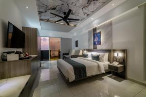 a bedroom with a large bed with a ceiling at Samann Blue in Hulhumale