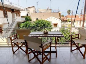 a dog sitting on a table on a balcony at Family Booklovers space in Aigio