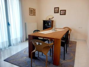 a dining room table and chairs in a room at Family Booklovers space in Aigio