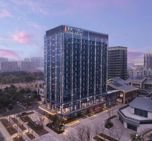 a tall building with lights on in a city at 苏州云启一方酒店-凯悦尚选 in Suzhou