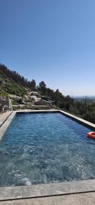a large swimming pool with a view of the ocean at Gardunha Stone in Louriçal do Campo