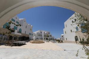 a view of a courtyard with white buildings at Klodian Durmishi in Vlorë