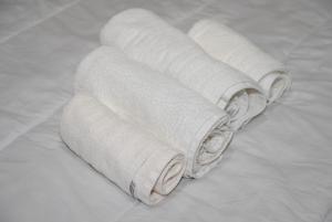 a group of white towels sitting on a bed at KAMVISSIS HOTEL in Tyros +65 photos