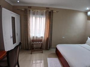 a hotel room with a bed and a window at Gosen Hotel Lubumbashi in Lubumbashi +74 photos