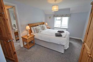 a bedroom with a large white bed and a window at Naam Place in Lincoln