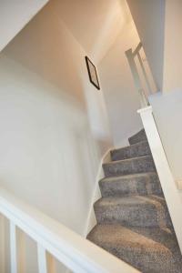 a staircase in a house with a picture on the wall at Naam Place in Lincoln