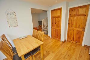 a dining room with a table and a wooden door at Naam Place in Lincoln +14 photos