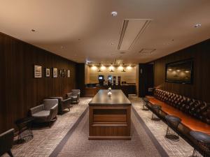 a waiting room with a long table and chairs at Yokohama Sakuragicho Washington Hotel in Yokohama