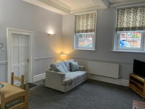 a living room with a chair and a tv at Hursley Lodge in Lincoln