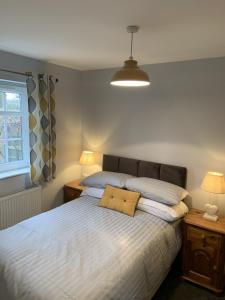 a bedroom with a bed with two pillows on it at Hursley Lodge in Lincoln