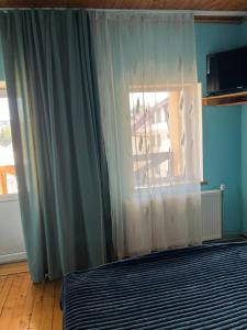 a bedroom with a bed and a window at Villa Maria in Slavske