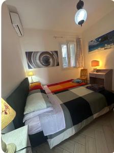 a bedroom with a large bed and a desk at Casa del sasso in Bergeggi