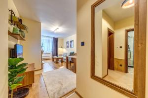a large mirror in a hallway with a living room at Ember Suite 1BR - Mountain Lake Complex By Flat Mаnager in Smolyan