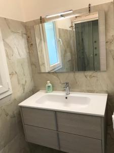 a bathroom with a white sink and a mirror at Casa del sasso in Bergeggi +56 photos