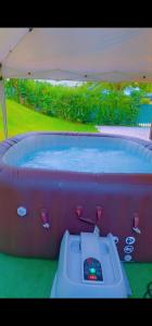 a hot tub with a remote control in it at Emma modern suite in Kourou +6 photos
