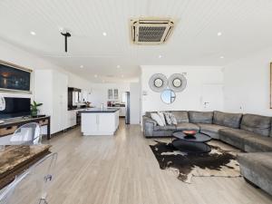 a living room with a couch and a table at The Coastal Crown in Ballito +21 photos