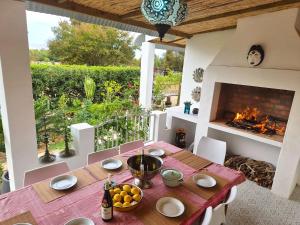 a dining room with a table and a fireplace at Django's in Riebeek-Kasteel