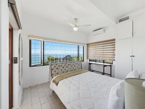 a bedroom with a large bed and a large window at The Coastal Crown in Ballito