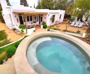 a large swimming pool in front of a house at Django's in Riebeek-Kasteel