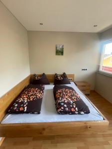 a bed in a room with two pillows on it at Penthouse Ferienwohnung- 3 Schlafzimmer in Naturno