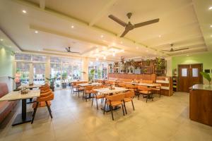 a restaurant with tables and chairs in a room at Ritz Valley Resort in Mahabaleshwar