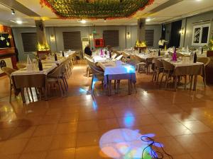 a dining room with tables and chairs with people sitting at them at Elflora Otel in Ceyhan