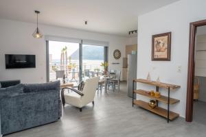 a living room with a couch and a table at Ocean Breeze Residence in Kámpos