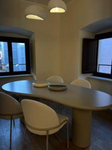 a dining room with a table and chairs at Cavour Apartment in LʼAquila