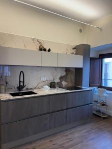 a kitchen with a sink and a counter top at Cavour Apartment in LʼAquila