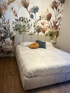a bedroom with a bed with a floral wallpaper at Cavour Apartment in LʼAquila +58 photos