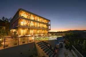 a large building with a swimming pool in front of it at Ritz Valley Resort in Mahabaleshwar