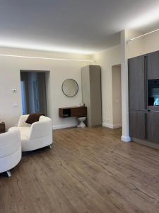 a living room with a white couch and a table at Cavour Apartment in LʼAquila