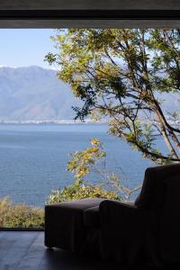 a living room with a view of the water at Arcadia anyin qingshan hotel in Dali Shuanglang