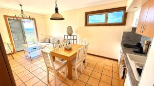 a kitchen and dining room with a table and chairs at Casa Sol e Praia in Porto Santo