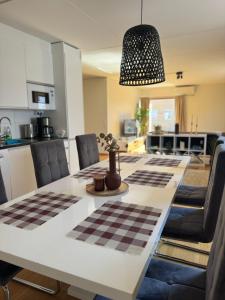a kitchen and dining room with a checkered table at Strandis in Mariehamn