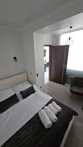 a bedroom with a large bed with two towels on it at Apartament Sun Hill in Wisła