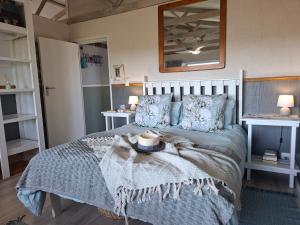 a bedroom with a bed with a hat on it at Reebok Rest in Reebok