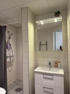 a bathroom with a sink and a mirror at Strandis in Mariehamn +17 photos
