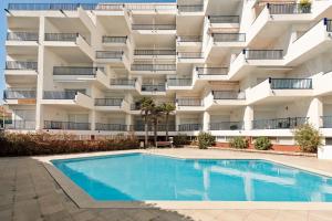 an apartment building with a swimming pool in front of it at La Escala- Costa Brava pool duplex apartment in L'Escala