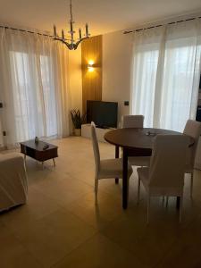 a dining room with a table and chairs and a television at TedHouse in Praia a Mare