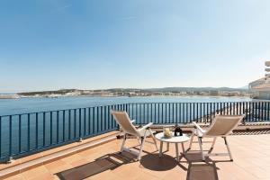 a table and chairs on a balcony with a view of the water at La Escala- Costa Brava pool duplex apartment in L'Escala