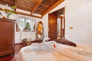 a bedroom with a bed with a swan on it at La Paredita Casa Taoro in Tanque +43 photos