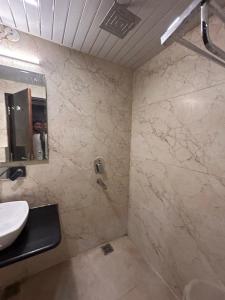 a bathroom with a shower and a sink at Laddu Resort in Bhīm Tāl
