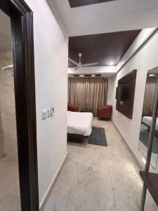 a room with a bedroom with a bed and a door at Laddu Resort in Bhīm Tāl +5 photos