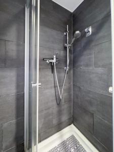 a shower stall in a bathroom with a shower at City-Apartment Spreeufer im Herzen Berlins in Berlin +9 photos