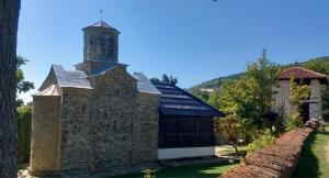 an old stone building with a tower and a barn at Ramaća House in Ramaća +4 photos